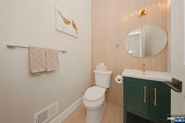 a bathroom with a toilet a sink and mirror