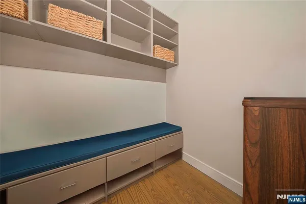 a small space with wooden floor and a window