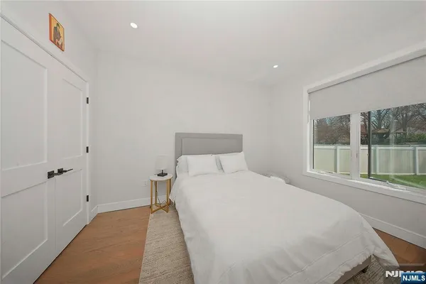 a bedroom with a bed and a large window