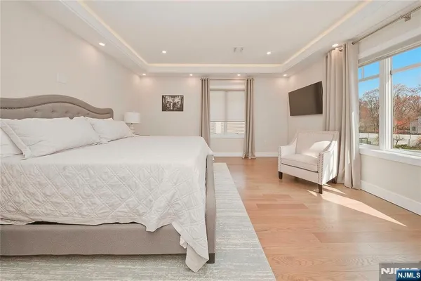 a spacious bedroom with a bed and glass door