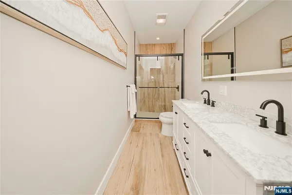 a spacious bathroom with a sink a mirror and shower