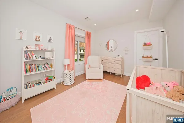 a bedroom with furniture and a book shelf
