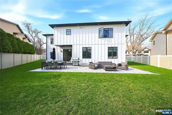 a view of a house with backyard and sitting area