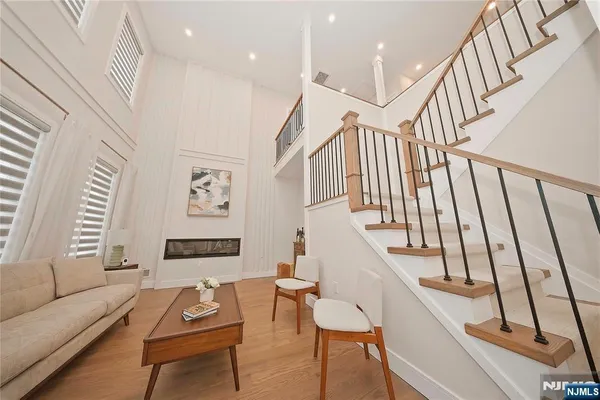 a living room with furniture and stairs