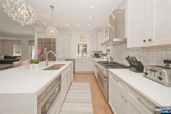 a large kitchen with a sink and cabinets
