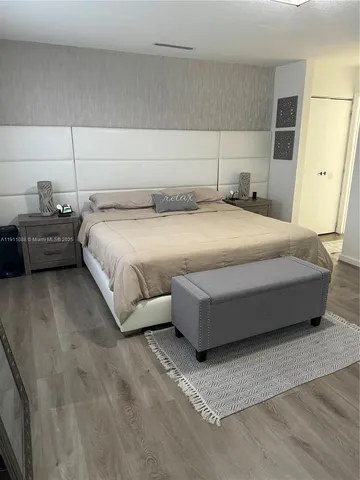 a bedroom with a bed and a night stand