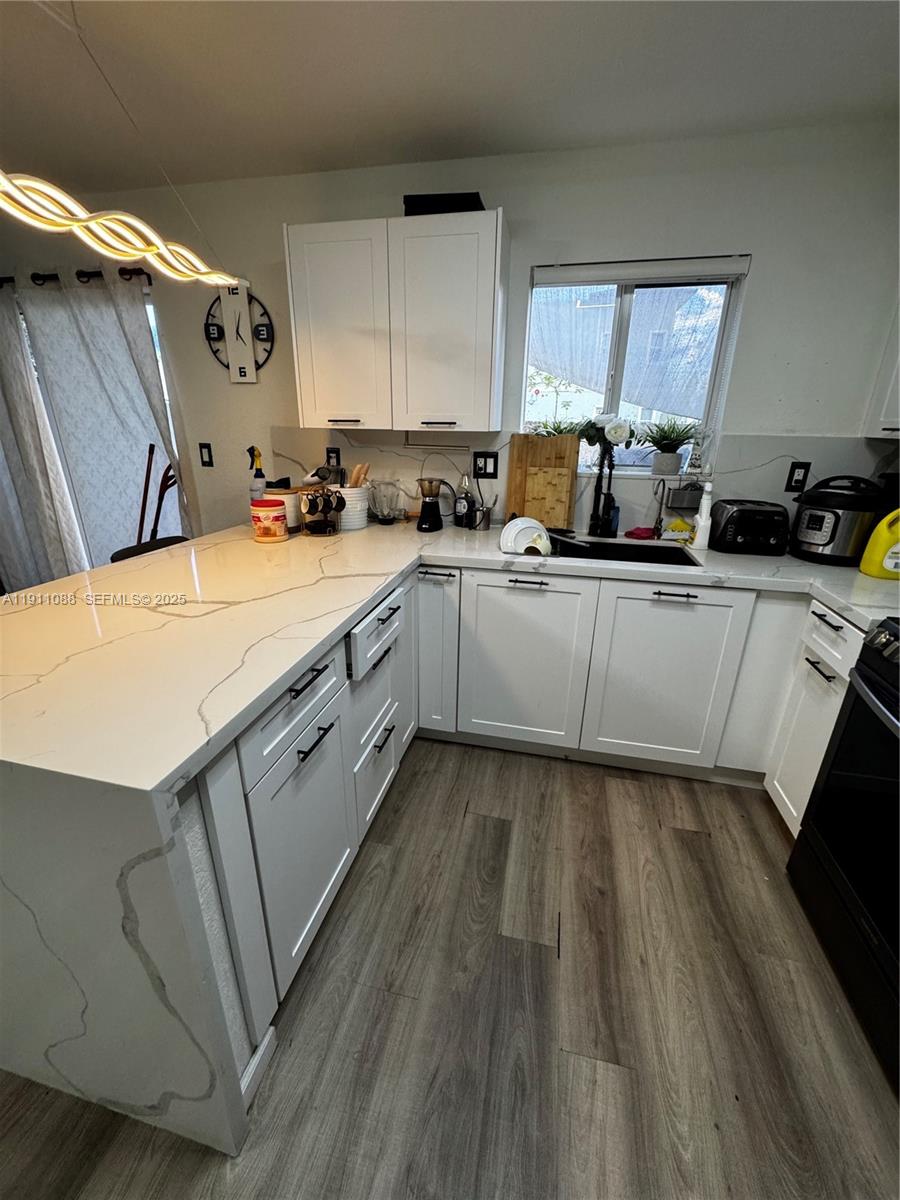 167 Southwest 6th Lane Florida City, FL 33034 - Photo 4 of 19 a kitchen with cabinets a sink and appliances