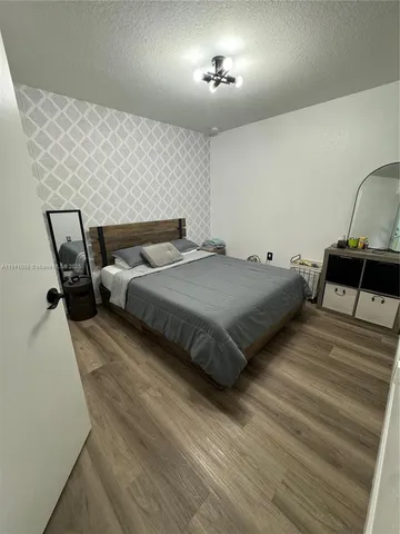a bedroom with a bed and a mirror