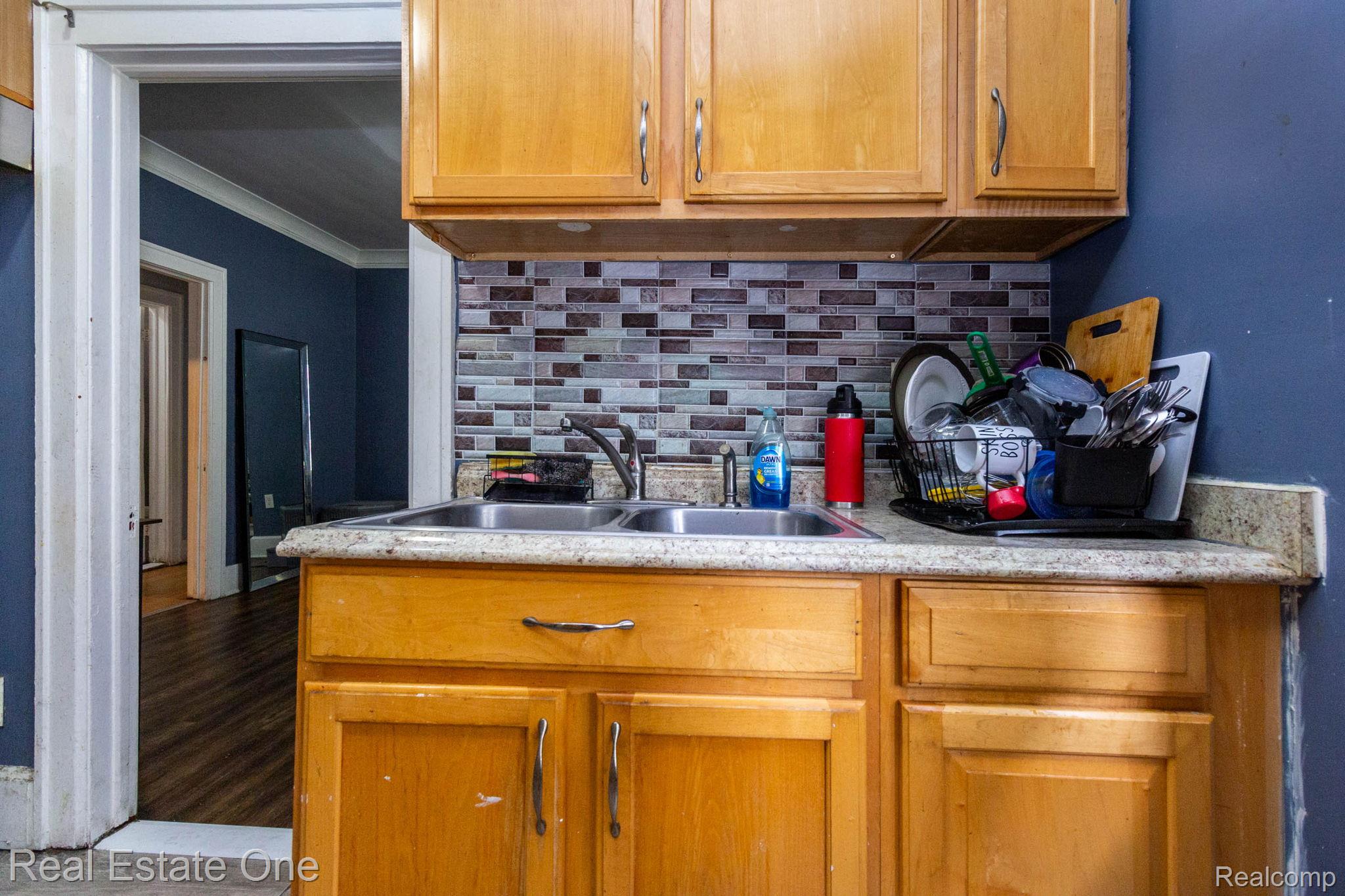 5485 Springwells Street Detroit, MI 48210 - Photo 20 of 47 Kitchen with light wood cabinetry and a mosaic tile backsplash
