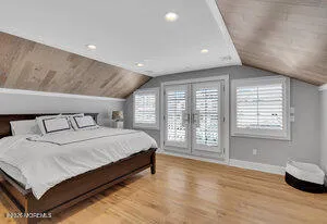 a spacious bedroom with a large bed and a large window