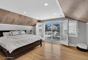 a spacious bedroom with a bed and a walk in closet