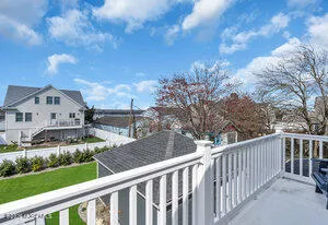 a view of a balcony with yard