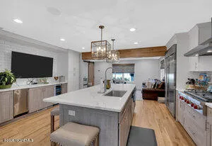 a kitchen with stainless steel appliances a stove a sink and a refrigerator