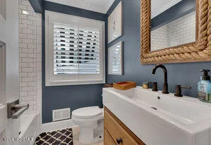 a bathroom with a sink a toilet and a bathtub