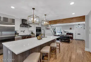 a kitchen with sink cabinets and wooden floor