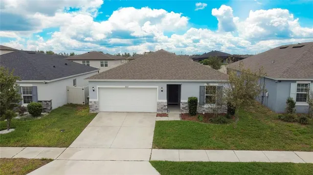 a front view of house with yard and green space