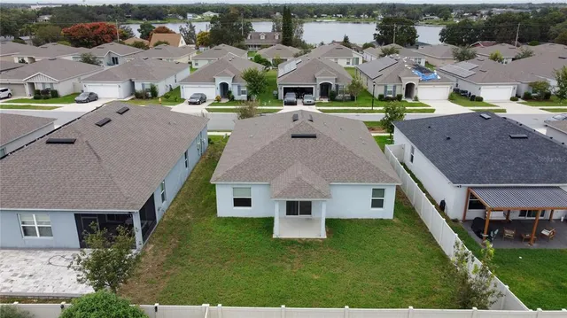 an aerial view of a house with a yard