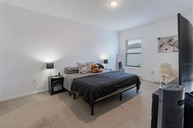 a bedroom with a bed and lamp