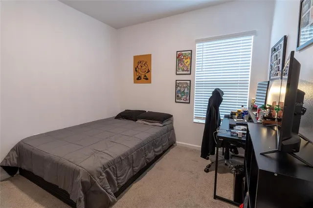 a bedroom with a bed and a desk