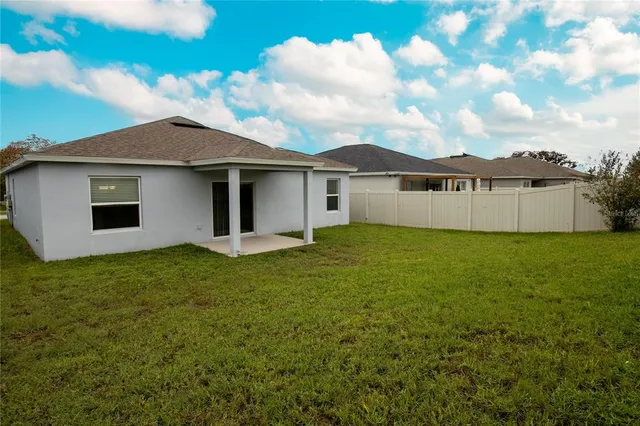 a view of a house with a backyard