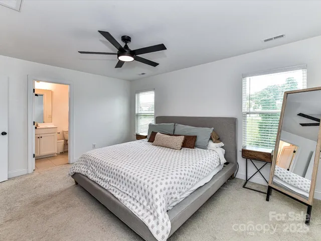 a bedroom with a bed couch and window