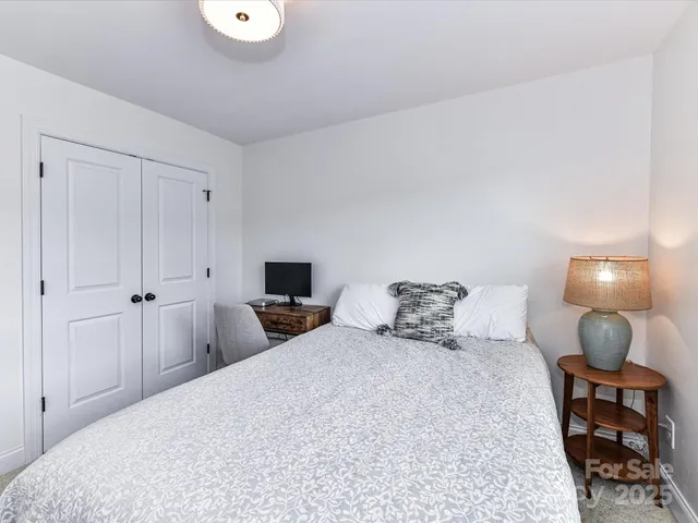 a bedroom with a bed and a lamp