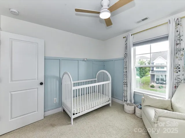a view of a room with windows & ceiling fan