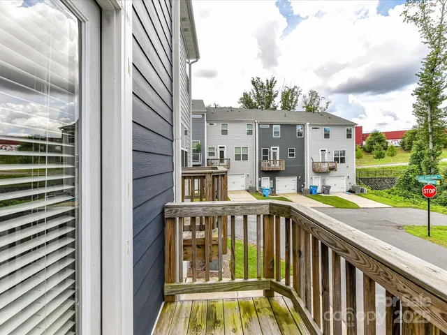 a view of a balcony with yard