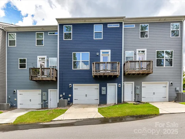 a view of a brick house with many windows and a table