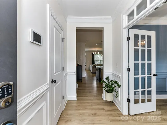 a view of a hallway with wooden floor and entryway