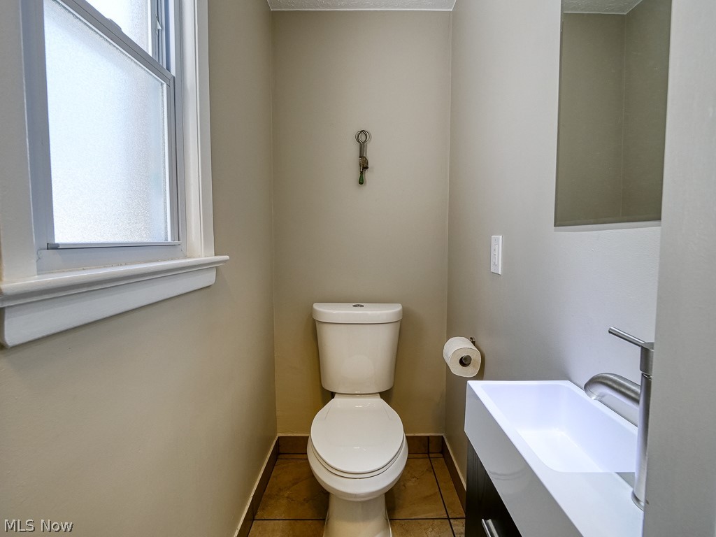 3844 Severn Road Cleveland Heights, OH 44118 - Photo 13 of 35 Conveniently located powder room off the kitchen, new sink/vanity, toilet, tile flooring.