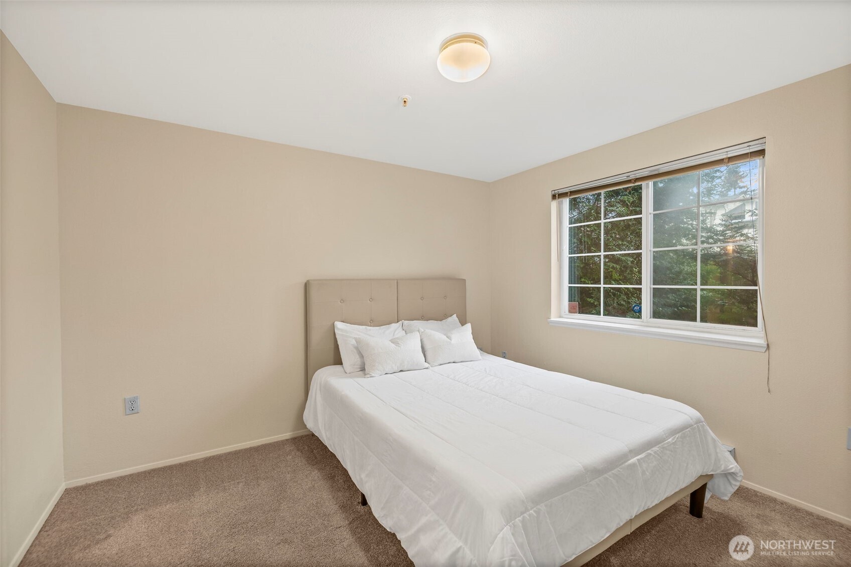 10824 Southeast 170th Street, Unit B103 Renton, WA 98055 - Photo 16 of 31 a bedroom with a bed and a window