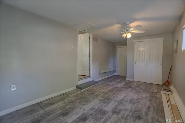 an empty room with a empty space and a ceiling fan