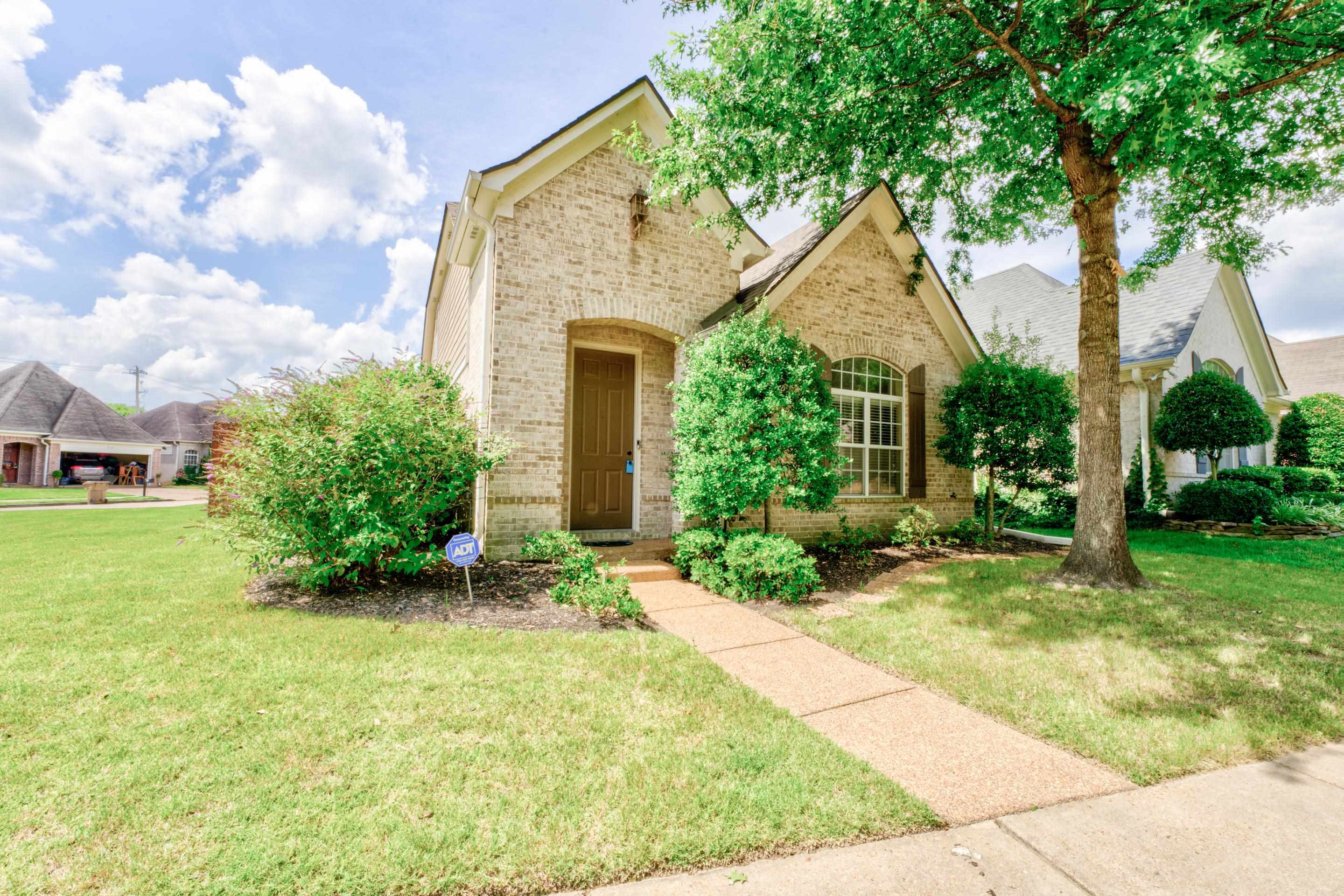 a view of house with backyard and garden