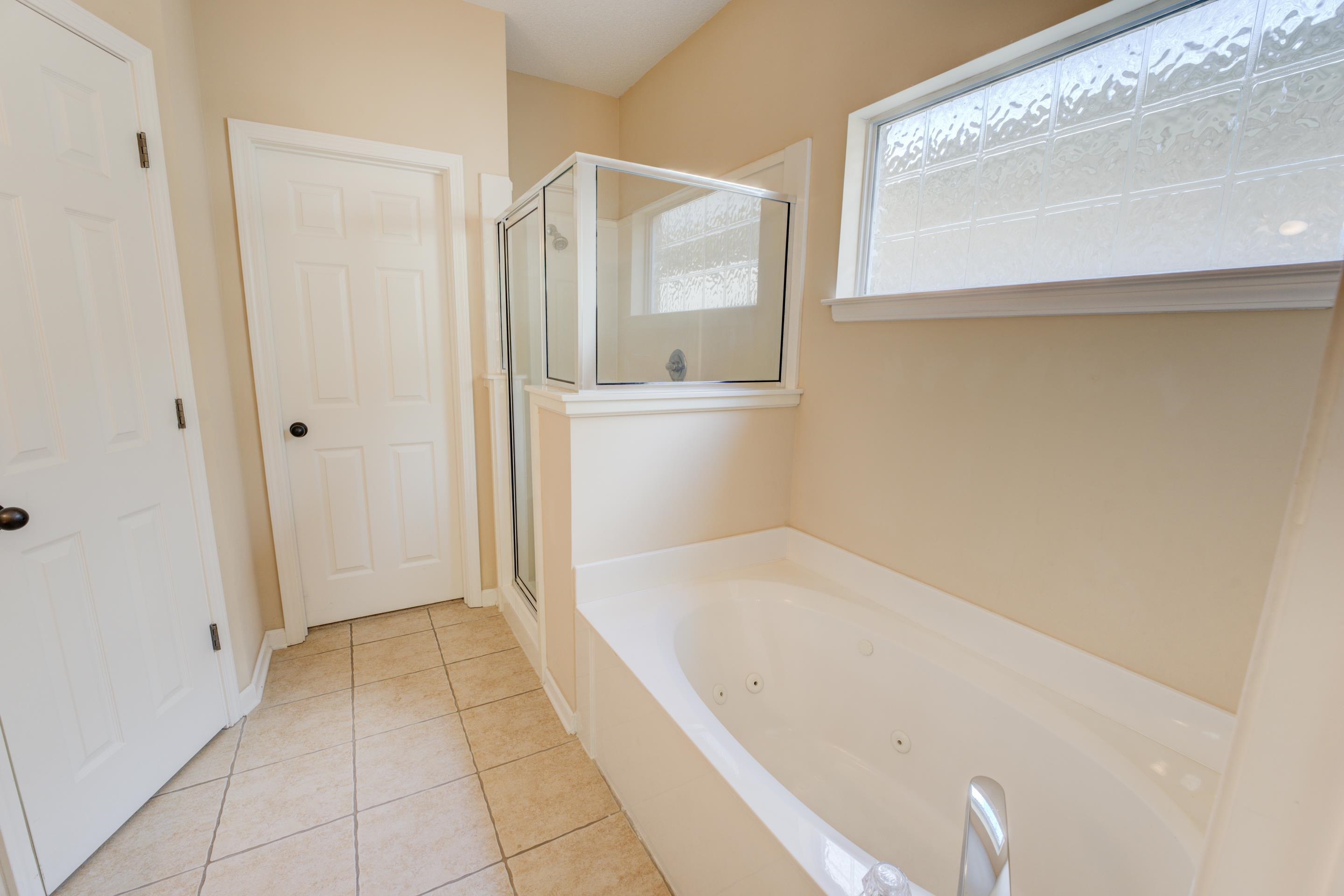 7243 Grapetree Trail Cordova, TN 38018 - Photo 7 of 20 a bathroom with a bathtub and a shower