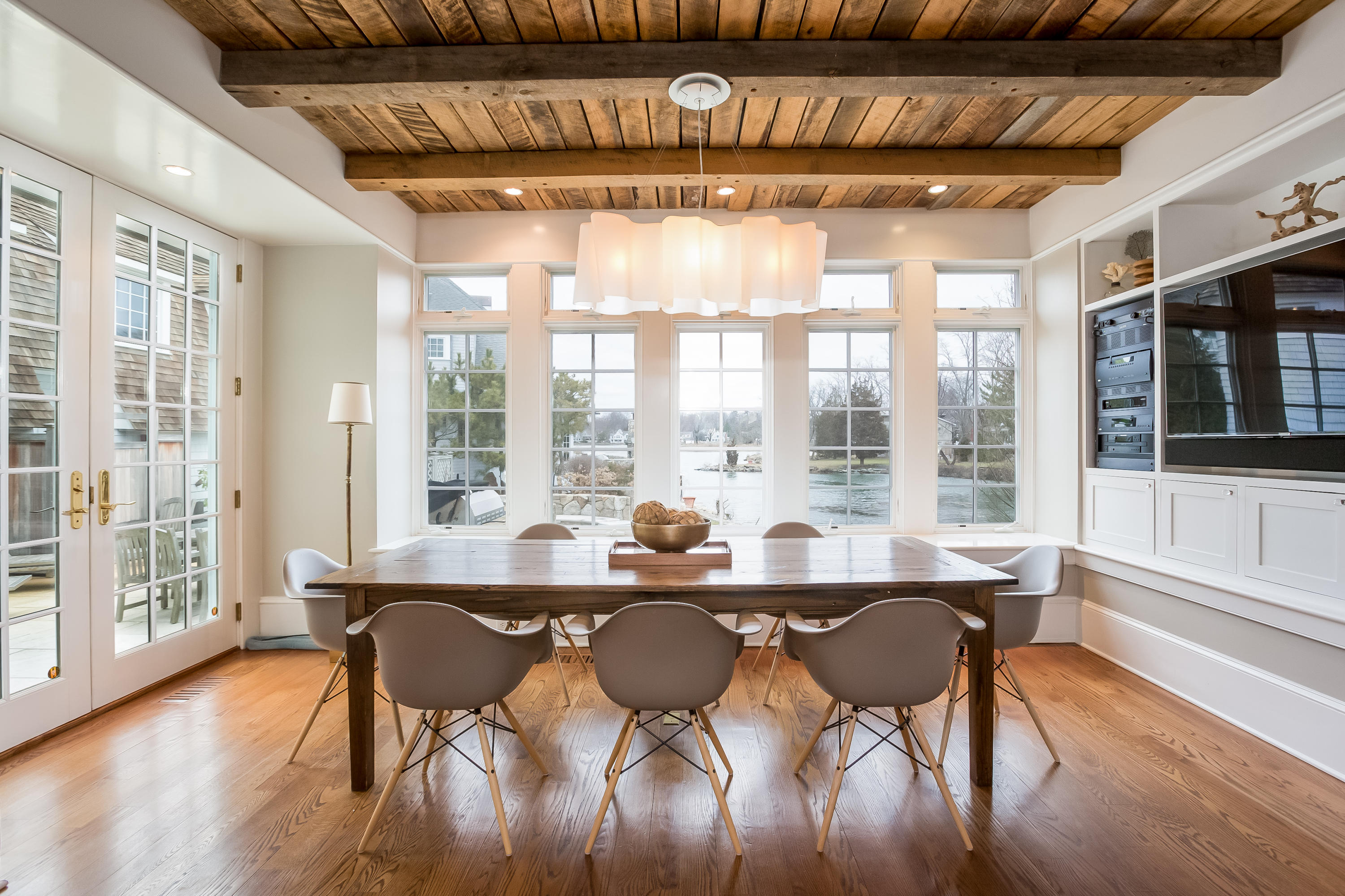 13 Crescent Beach Road Rowayton, CT 06853 - Photo 17 of 40 a dining room with furniture a chandelier and wooden floor
