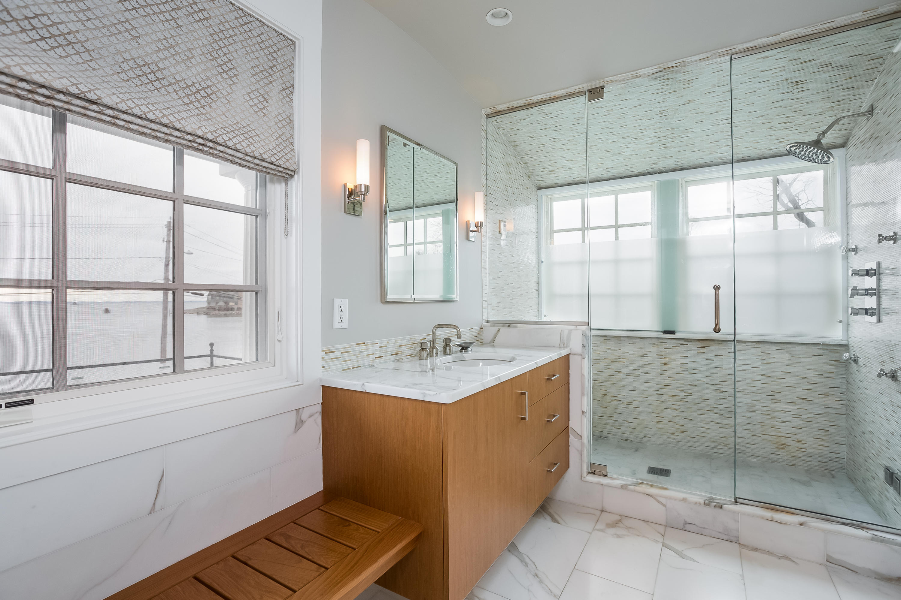13 Crescent Beach Road Rowayton, CT 06853 - Photo 23 of 40 a bathroom with a shower sink and mirror