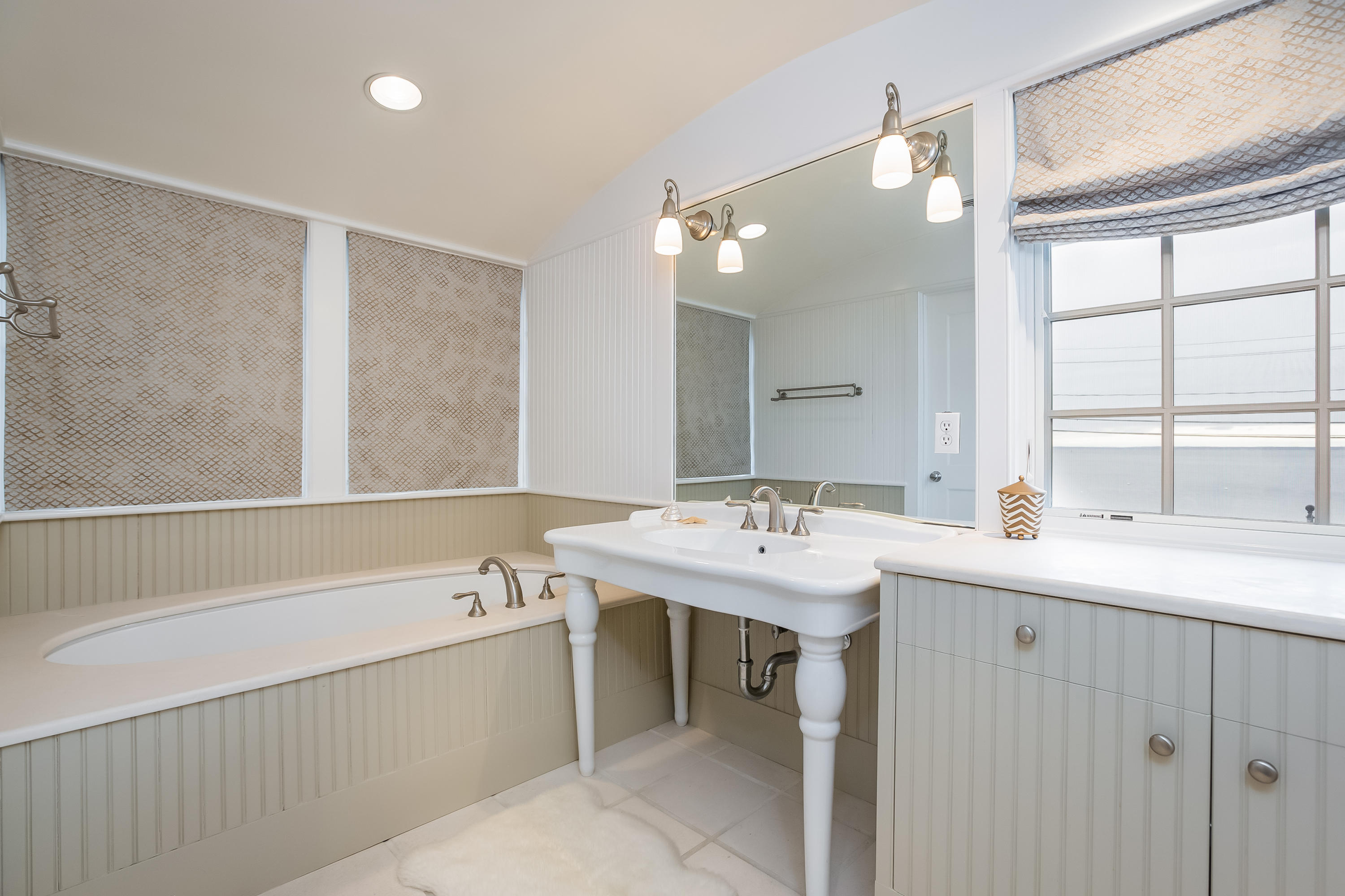 13 Crescent Beach Road Rowayton, CT 06853 - Photo 24 of 40 a bathroom with a sink a large mirror and a bathtub