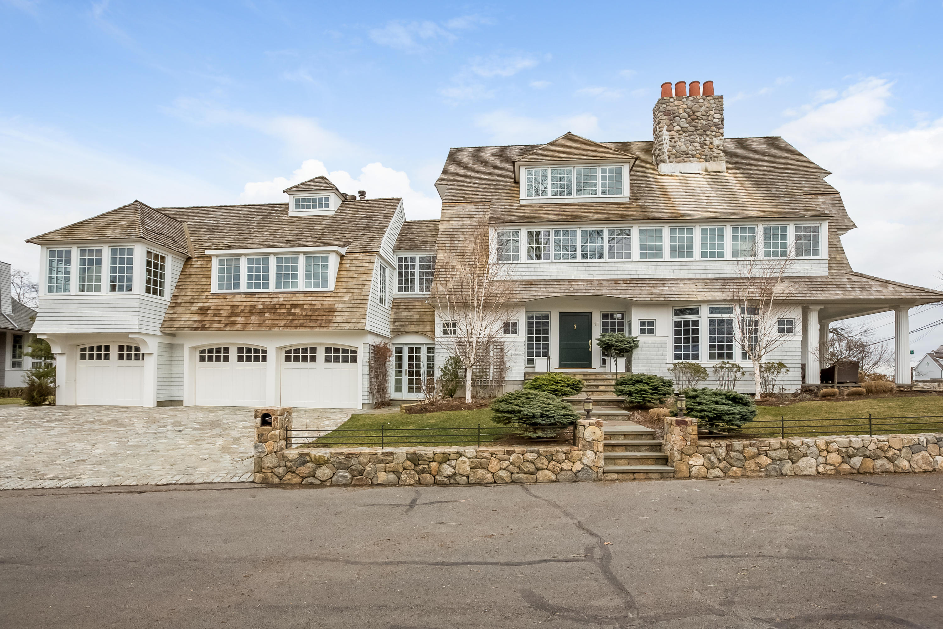 13 Crescent Beach Road Rowayton, CT 06853 - Photo 3 of 40 a front view of a residential apartment building with a yard