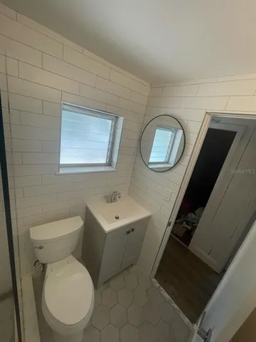 a white toilet sitting next to a bathroom sink