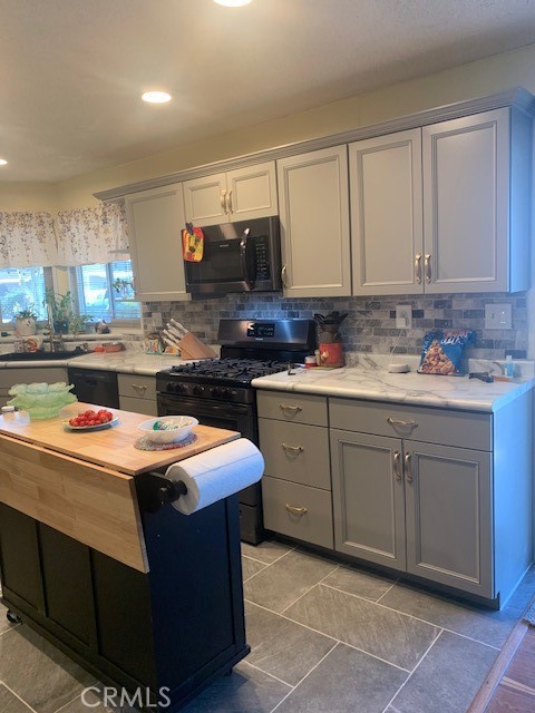 a kitchen with a sink stove and cabinets