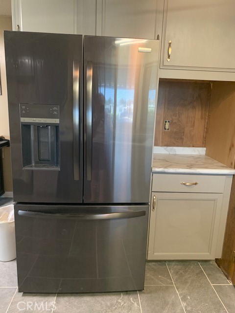 4401 Camelot Place Bakersfield, CA 93301 - Photo 24 of 37 a view of a refrigerator in kitchen and an empty room