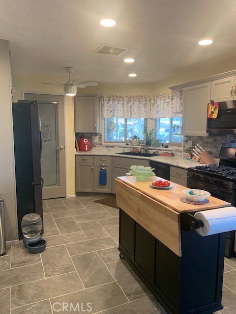 4401 Camelot Place Bakersfield, CA 93301 - Photo 32 of 37 a kitchen with a sink and cabinets