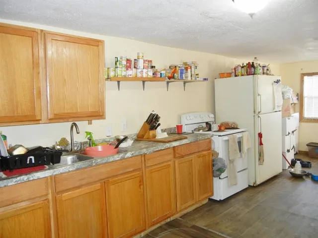 a kitchen with cabinets a sink and a refrigerator