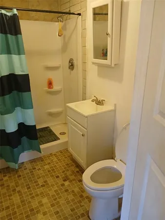 a bathroom with a sink a toilet and mirror