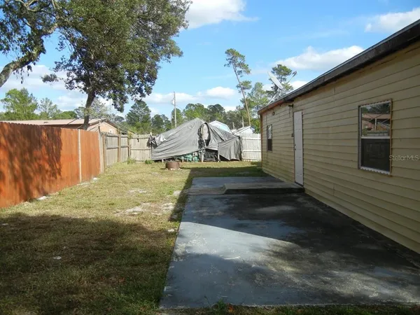 a view of a backyard of the house