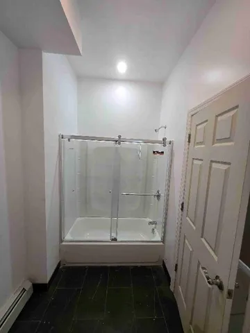 en empty room with windows and ceiling fan