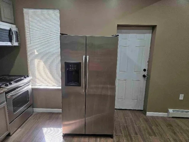 a kitchen with a refrigerator and a stove