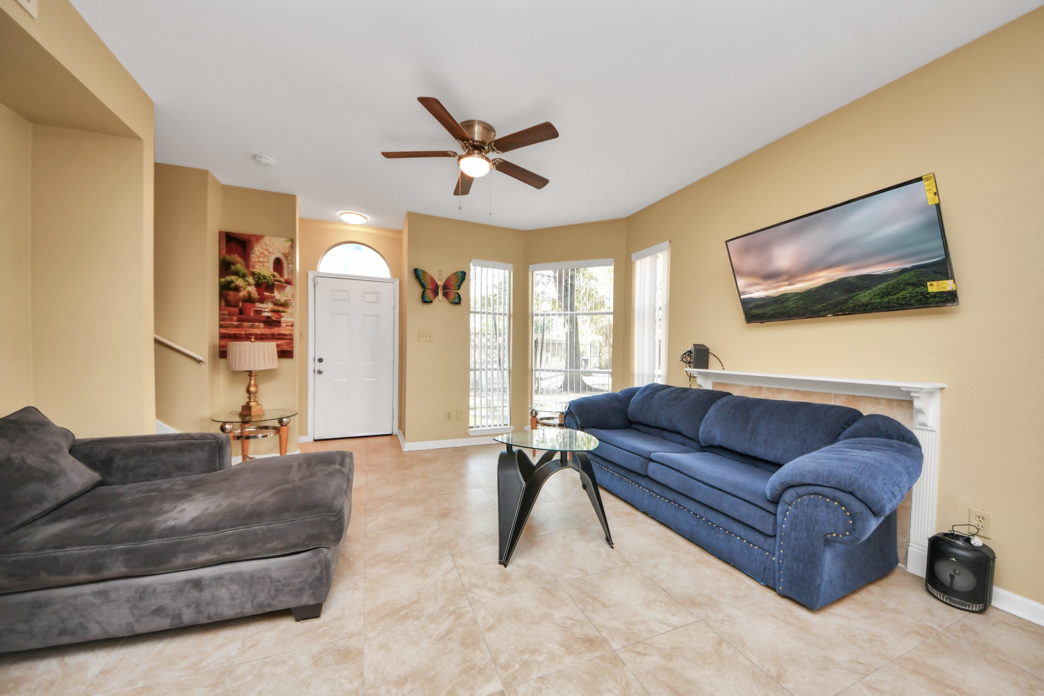 13620 Rosewood Street, Unit 3A Houston, TX 77083 - Photo 12 of 25 a living room with furniture and a flat screen tv