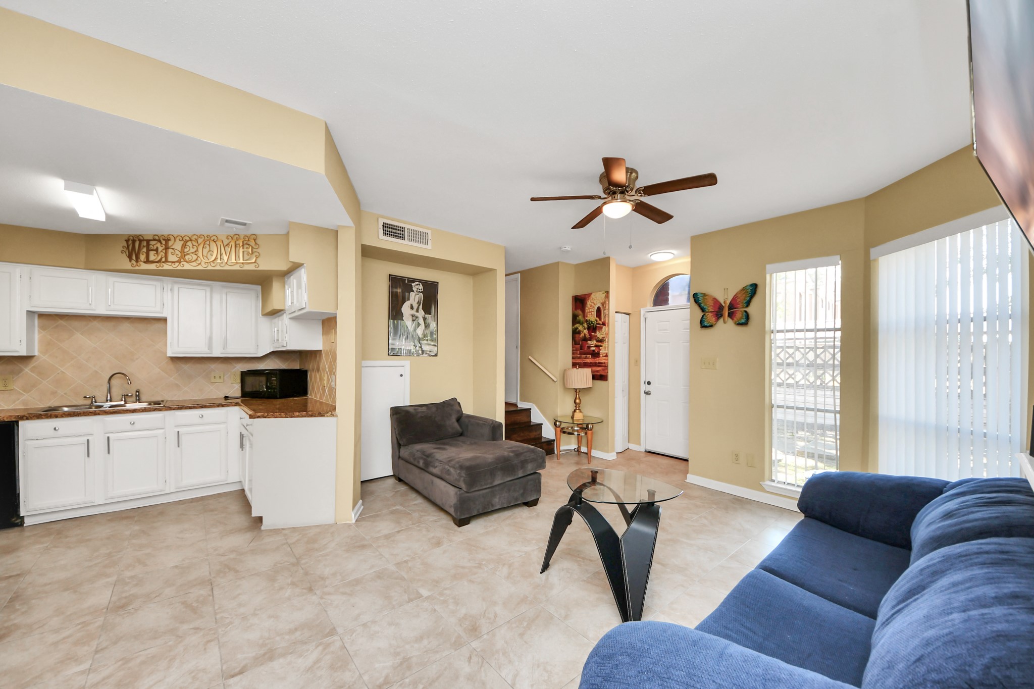 13620 Rosewood Street, Unit 3A Houston, TX 77083 - Photo 13 of 25 a living room with furniture and a large window